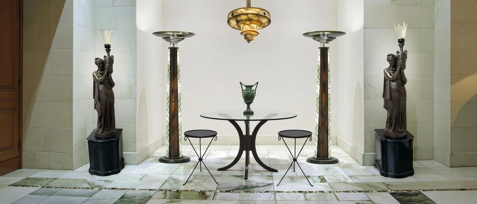 Antique floor lamps in an elegant setting with tables and chairs.
